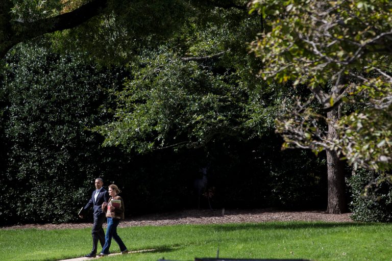 President Barack Obama (L) walks with Jennifer Palmieri, assistant to the president and communications director, on his way to a motorcade to visit volunteers at a Martha's Table kitchen Oct. 14, 2013 in Washington, D.C. (Photo by T.J. Kirkpatrick-Pool/Getty images)