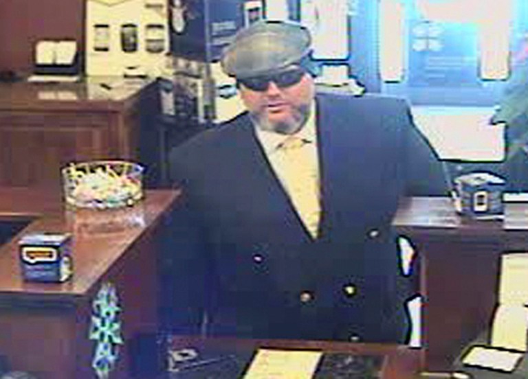 File-A file image provided by the Jackson, Wyo., Police Department shows Corey Donaldson, a 39-year-old Australian, during a bank robbery on New Year's Eve, 2012, at the U.S. Bank in Jackson, Wyo. Donaldson is standing trial in Wyoming says he was justified in robbing a Jackson bank because he gave the money to the homeless. (AP Photo/Jackson Police Department,File)