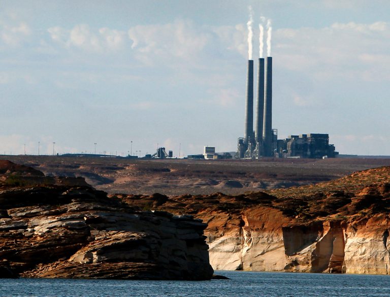FILE - This Sept. 4, 2011, file photo shows the main plant facility at the Navajo Generating Station, as seen from Lake Powell in Page, Ariz. The federal government has come up with a final version of a rule meant to cut haze-causing emissions from the largest coal-fired power plant in the West. The U.S. Environmental Protection Agency's decision Monday, July 28, 2014, reflects a compromise by tribal and federal officials, environmental groups and the owners of the Navajo Generating Station, which is on track to cease operations in 2044. (AP Photo/Ross D. Franklin, File)