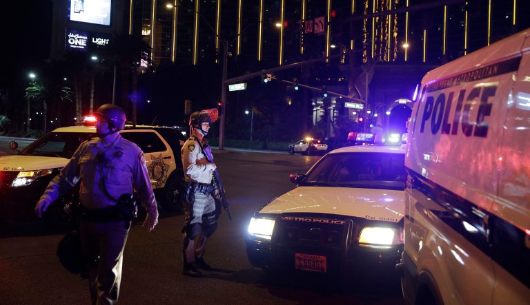 Police officers stand along the Las Vegas Strip outside the Mandalay Bay resort and casino during a deadly shooting near the casino, Sunday, Oct. 1, 2017, in Las Vegas. Multiple victims were being transported to hospitals after a shooting late Sunday at a music festival on the Las Vegas Strip. (AP Photo/John Locher)