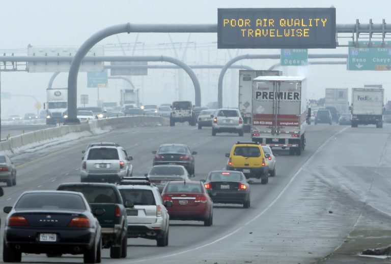 FILE - This Jan. 23, 2013, file photo, shows a poor air quality sign is posted over a highway, in Salt Lake City.  A new government report released Jan. 13, 2014, says energy-related carbon dioxide pollution increased slightly in 2013 after declining for several years in a row.  (AP Photo/Rick Bowmer, File)