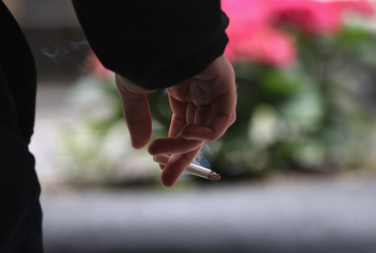 A smoker enjoys a cigarette outside an office building on April 23, 2013 in New York City. (Photo by John Moore/Getty Images)