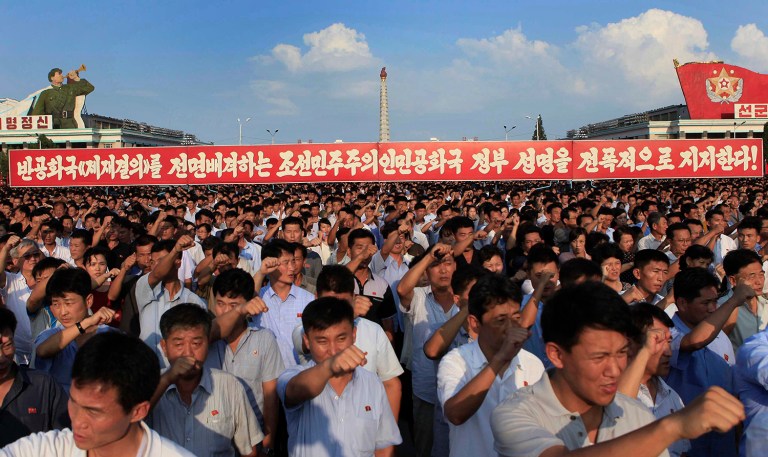 Tens of thousands of North Koreans gathered for a rally at Kim Il Sung Square carrying placards and propaganda slogans as a show of support for their rejection of the United Nations' latest round of sanctions on Wednesday Aug. 9, 2017, in Pyongyang, North Korea. (AP Photo/Jon Chol Jin)