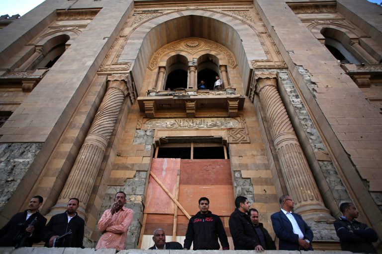 Egyptian security officers stand guard at the entrance of the Museum of Islamic Art after an explosion at the Egyptian police headquarters in downtown Cairo, Friday, Jan. 24, 2014. Egypt's antiquities minister says the car bombing that struck the main police headquarters in Cairo earlier in the day has caused major damage to the nearby Islamic art museum.(AP Photo/Khalil Hamra)