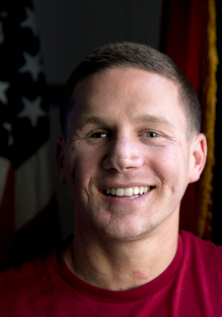 This photo taken May 13, 2014 shows Medically retired Marine Lance Cpl. Kyle Carpenter speaking to media at the Pentagon. On June 19, 2014, President Barack Obama will award Carpenter the Medal of Honor for his courageous actions while serving as an Automatic Rifleman with Company F, 2d Battalion, 9th Marines, Regimental Combat Team 1, 1st Marine Division (Forward), I Marine Expeditionary Force (Forward), in Helmand Province, Afghanistan. (AP Photo/Carolyn Kaster)