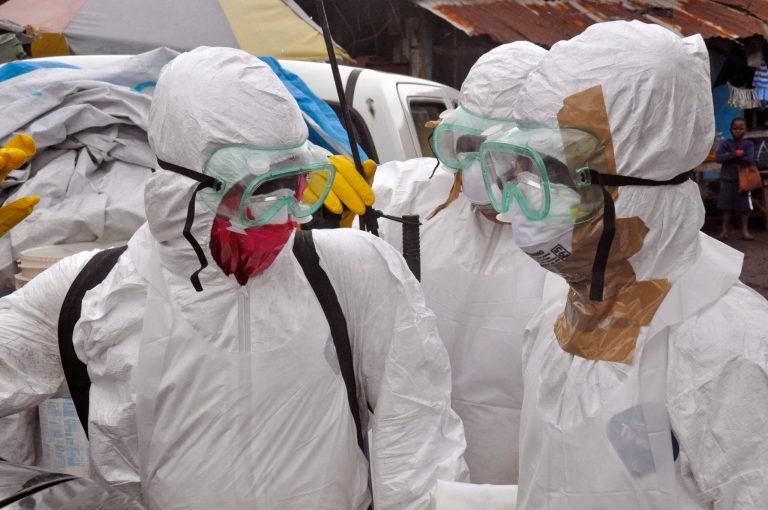 Health workers in protective gear leave after carrying the body of a woman that they suspect died from the Ebola virus, in an area known as Clara Town in Monrovia, Liberia, Wednesday, Sept. 10, 2014. A surge in Ebola infections in Liberia is driving a spiraling outbreak in West Africa that is increasingly putting health workers at risk as they struggle to treat an overwhelming number of patients. A higher proportion of health workers has been infected in this outbreak than in any previous one. (AP Photo/Abbas Dulleh)