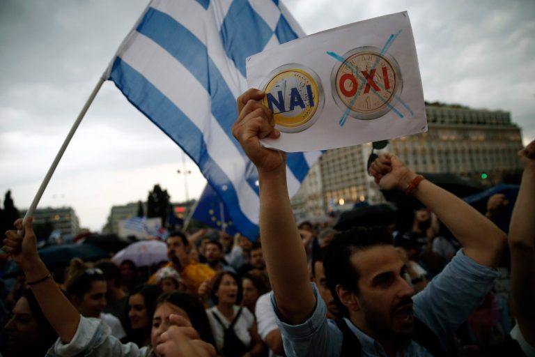 A demonstrator holds a placard depicting Yes to euro, No to drachma during a rally organized by supporters of the YES vote to the upcoming referendum in Athens, Tuesday, June 30, 2015. (AP Photo/Daniel Ochoa de Olza)
