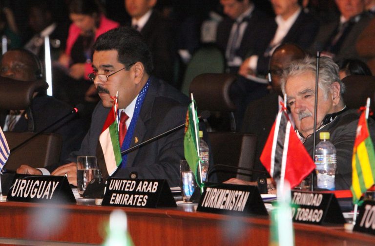 Venezuela's President Nicolas Maduro, left, speaks as Uruguay's President Jose Mujica listens to him, during the G77 + China Summit in Santa Cruz, Bolivia, Sunday, June 15, 2014. (AP Photo)