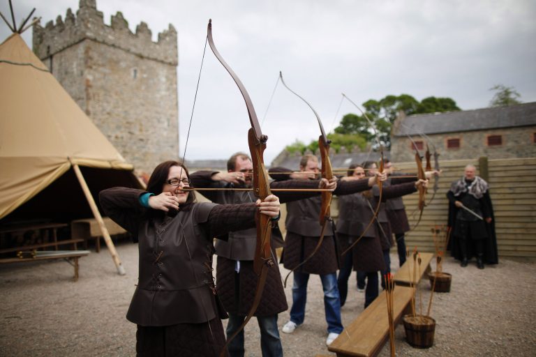 In this photo taken June 13, 2014, Game of Thrones tourists take part at clearsky adventure which has built an exact replica of Winterfell Archery range in the same spot where filming took place at  castleward, Strangford, Northern Ireland. (AP Photo/Peter Morrison)