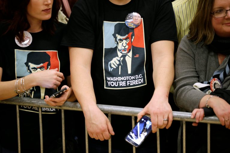 Audience members listen as Republican presidential candidate Donald Trump speaks during a campaign rally at Clinton Middle School, Saturday, Jan. 30, 2016, in Clinton, Iowa. (AP Photo/Charlie Neibergall)