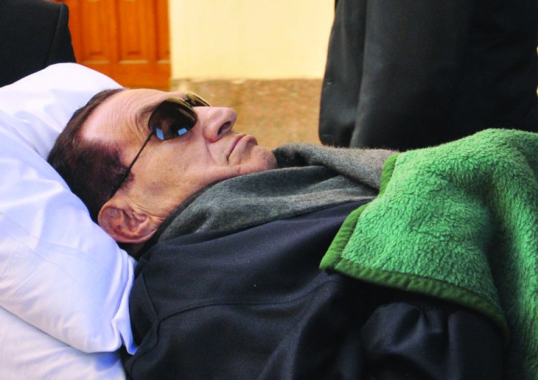 FILE - In this Monday, Jan. 9, 2012 file photo, former Egyptian president Hosni Mubarak is wheeled into a court house in Cairo, Egypt. Mubarak was in a coma on Wednesday but off life support and his heart and other vital organs were functioning, according to security officials. (AP Photo/Mohammed al-Law, File)