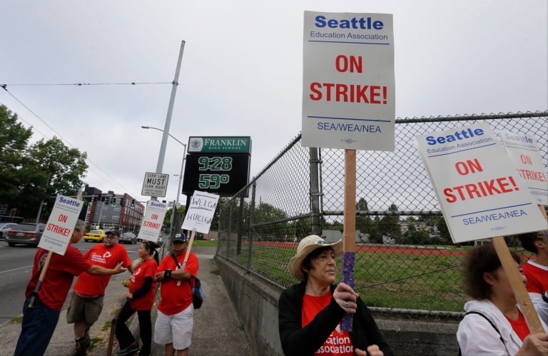 Striking Seattle School District teachers and other educators walk a picket line, Thursday, near Franklin High School in Seattle. (AP Photo/Ted S. Warren)