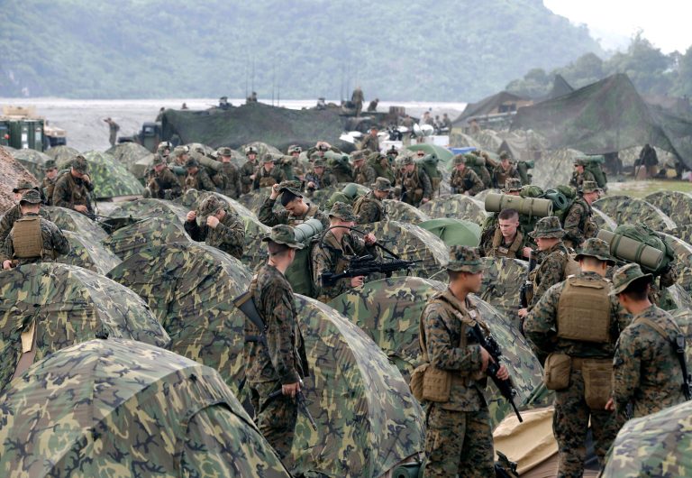 U.S. Marines fix their tents as they arrive at Crow Valley, Tarlac province in northern Philippines.