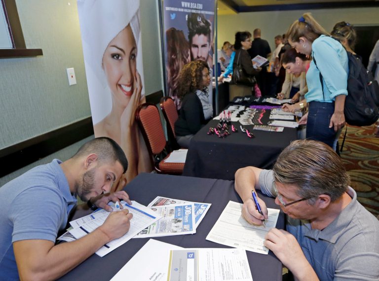 Job seekers fill out job applications at a job fair in Miami Lakes, Fla. (AP/Alan Diaz)