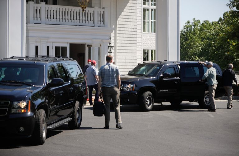 President Donald Trump, center, accompanied by members of the Secret Service are seen arriving at the Trump National Golf Club in Sterling, Va. (AP Photo/Pablo Martinez Monsivais)