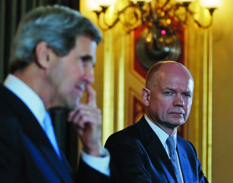 Britain's Foreign Secretary William Hague, right, watches as US Secretary of State John Kerry, left, answers a reporter's question during a joint news conference following their meeting in central London, Monday, Feb. 25, 2013. This is the first overseas trip for the US Secretary of State in his new role. (AP Photo/Lefteris Pitarakis, pool)
