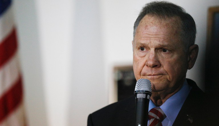 Former Alabama Chief Justice and U.S. Senate candidate Roy Moore has made a name for himself as the anti-establishment pick for Alabama's contested Senate seat. Two of Moore's advisers, however, have close ties with some particularly establishment politicians. (AP Photo/Brynn Anderson)