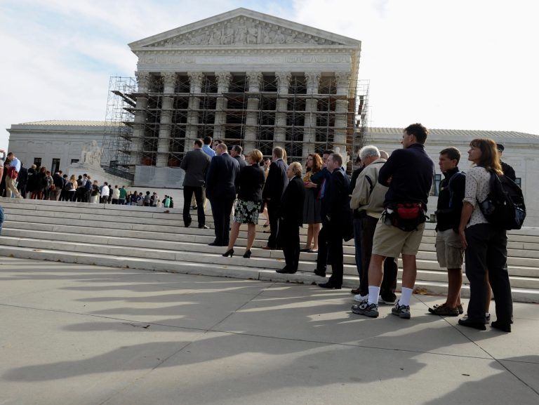 People stand in line outside the Supreme Court in Washington on Tuesday. (AP Photo/Susan Walsh)