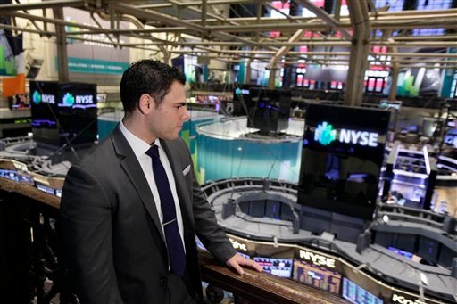 In this Wednesday, Aug. 1, 2012 photo, New York Stock Exchange Senior Compliance Associate Matthew Pizzo, an Air Force veteran who has law and business degrees, looks over the trading floor of the New York Stock Exchange. Pizzo had gone two years without work, until recently, as he is now finishing his first week of work at the exchange. U.S. employers added 163,000 jobs in July, a hopeful sign after three months of sluggish hiring. (AP Photo/Richard Drew)