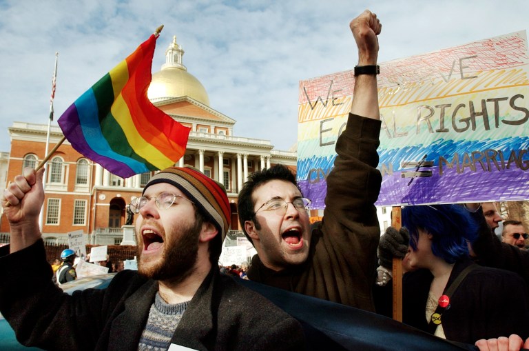 In this March 11, 2004 file photo, James Jenner, of Boston, left, and James Murphy, of Cambridge, Mass. show their support for same-sex marriage in front of the Statehouse in Boston. Several thousand people on both sides of the same-sex marriage issue gathered as state legislators debated a constitutional ban on gay marriage. Itâs been a decade since the highest court in Massachusetts issued its landmark ruling legalizing same-sex marriage by declaring that barring marriage for gay couples is unconstitutional. Since then, 14 other states and the District of Columbia have legalized gay marriage, with Illinois posed to become the 16th state next week when the governor is expected to sign a gay marriage bill into law. (AP/Steven Senne)
