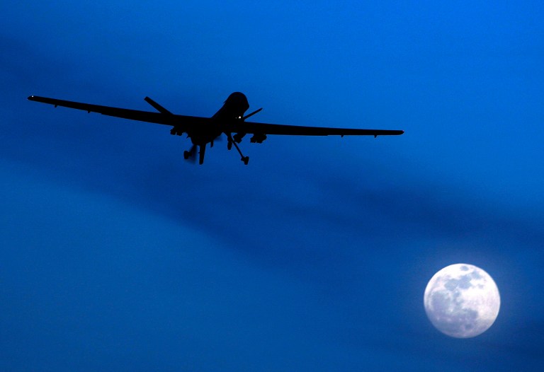 An unmanned U.S. Predator drone flies over Kandahar Air Field, southern Afghanistan, on a moon-lit night. (AP/Kirsty Wigglesworth)