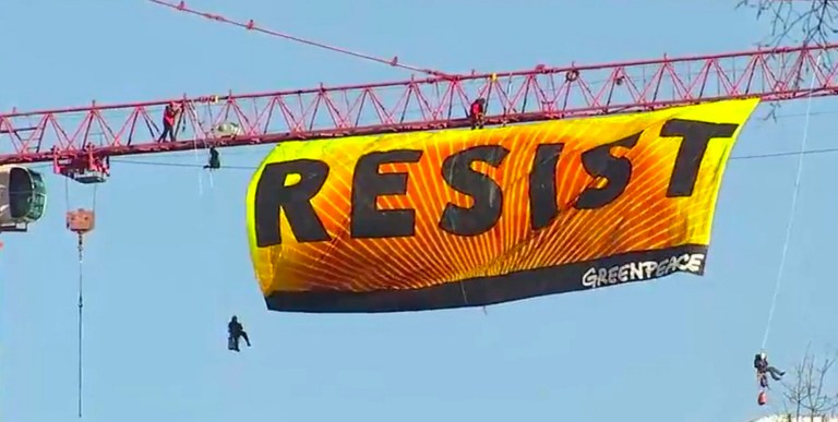Greenpeace protesters abandon crane, leave anti-Trump banner