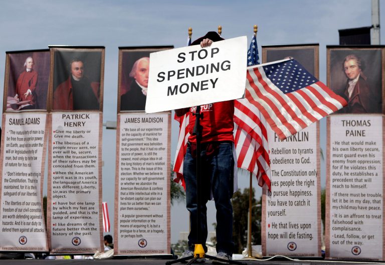Michael Fell, of Culver City, Calif., holds up a sign reading 