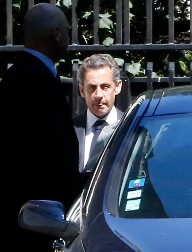 Former French President Nicolas Sarkozy leaves his house in Paris, Wednesday, July 2, 2014. Sarkozy, his lawyer and a magistrate are facing preliminary charges in a corruption investigation linked to allegations that he took 50 million euros ($67 million) in illegal campaign funds from Libya's Moammar Gadhafi, after a night of questioning by judicial officials. (AP Photo/Jacques Brinon)