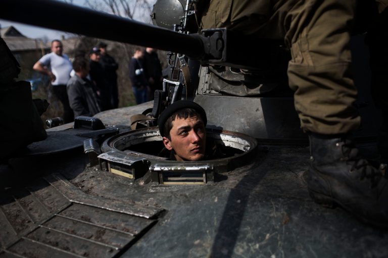A Ukrainian soldier is seen in a tank of the Ukrainian Army, as they are blocked by people on their way to the town of Kramatorsk on Wednesday, April 16, 2014. Pro-Russian insurgents commandeered six Ukrainian armored vehicles along with their crews and hoisted Russian flags over them Wednesday, dampening the central government's hopes of re-establishing control over restive eastern Ukraine. (AP Photo/Manu Brabo)