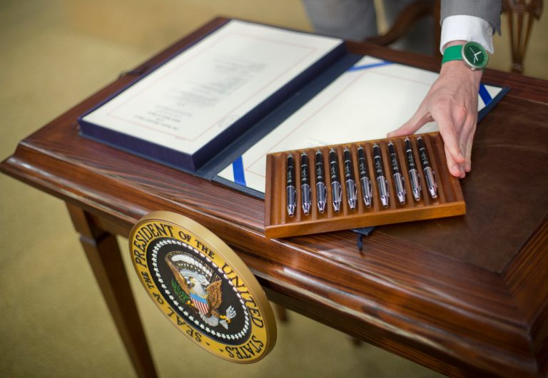 A White House staffer arranges the pens that President Barack Obama will use to sign bill H.R. 2576, the Frank R. Lautenberg Chemical Safety for the 21st Century Act., Wednesday, June 22, 2016. (AP Photo/Pablo Martinez Monsivais)