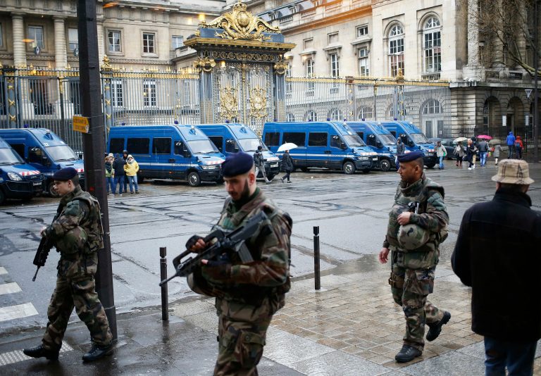 French soldiers patrol outside the Paris hall of Justice on March 30 while Frenchman Reda Kriket is being questioned by a magistrate who is expected to file preliminary terrorism charges. (AP Photo/Francois Mori)