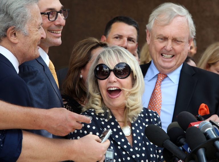 With her attorney Pierce O'Donnell, right, Shelly Sterling, center, talks to reporters after a judge ruled in her favor and against her estranged husband, Los Angeles Clippers owner Donald Sterling, in his attempt to block the $2 billion sale of the NBA basketball team, outside Los Angeles Superior Court Monday, July 28, 2014. (AP Photo/Nick Ut)