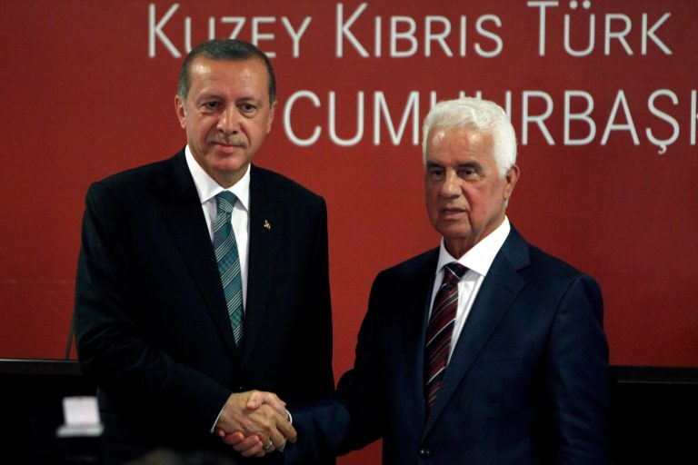 Turkey's new President Recep Tayyip Erdogan, left, and Turkish Cypriot leader Dervis Eroglu shake hands after a press conference and their meeting in the breakaway Turkish Cypriot north of ethnically divided Cyprus on Monday, Sept. 1, 2014. This is Erdogan's first visit abroad since his election last month. Cyprus was divided in 1974 when Turkey invaded after a coup by supporters of union with Greece. (AP Photo/Petros Karadjias)