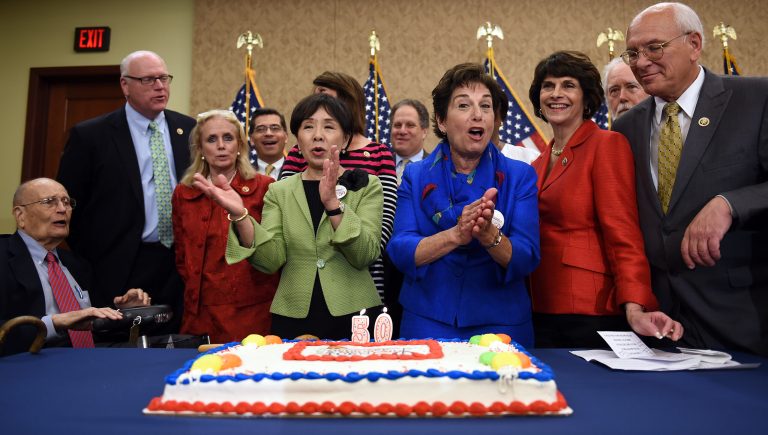 Rep. Jan Schakowsky (in blue) and other lawmakers celebrate the 50th anniversary of Medicare and Medicaid with a special cake on Capitol Hill. (Photo by Astrid Riecken/Getty Images)