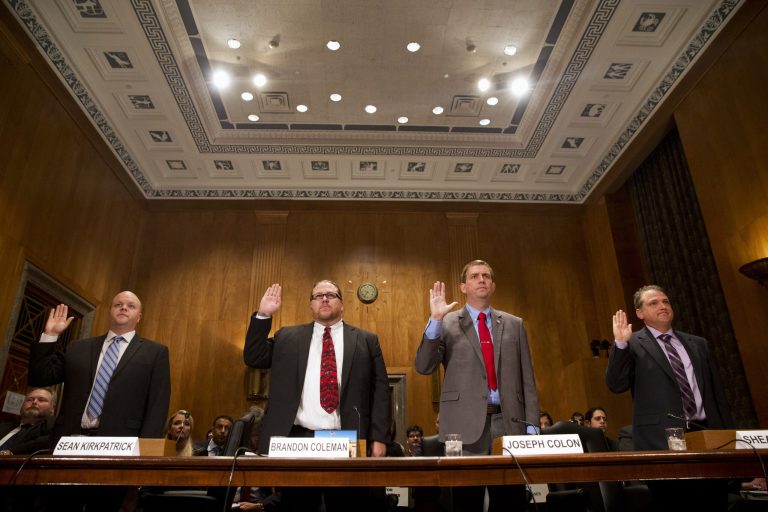 From left, Sean Kirkpatrick of Chicago; Phoenix VA Health Care System Addiction Therapist Dr Brandon Coleman; VA Caribbean Healthcare System Credentialing Program Support Joseph Colon, and Overton Brooks VA Medical Center Licensed Clinical Social Worker Shea Wilkes are sworn on Capitol Hill in Washington, Tuesday. (AP Photo/Jacquelyn Martin)