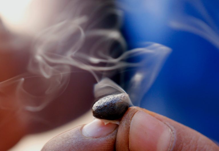 In this Sept. 14, 2014 photo, a worker inspects the crystalline resin powder 