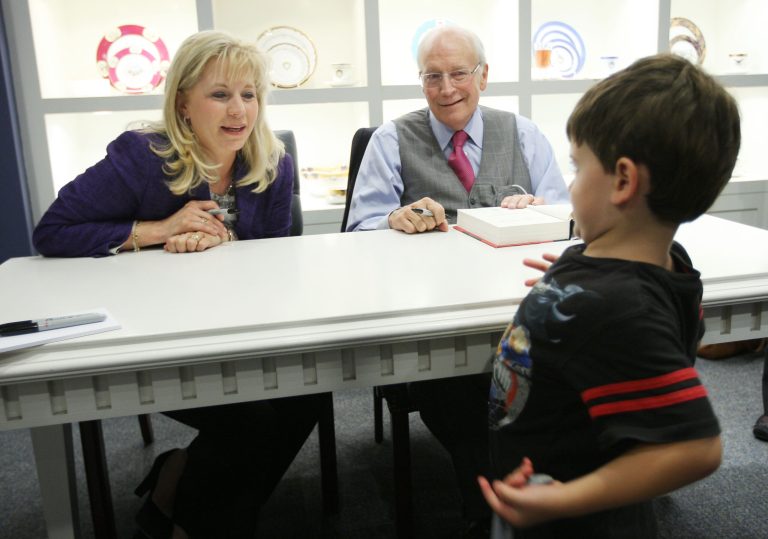 Four-year-old Joshua McBride shows his Batman shirt to Liz Cheney and her father former Vice President Dick Cheney during a tour for their book, 