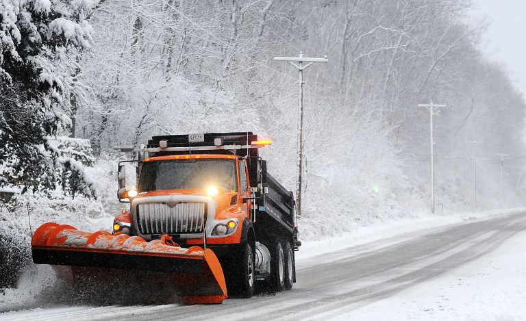   A snow plow clears off Old Homer Road, Sunday, Dec. 9, 2012, near Winona, Minn. The National Weather Service is predicting a total accumulation of five to 10 inches by Monday morning. (AP Photo/Winona Daily News, Joe Ahlquist)  