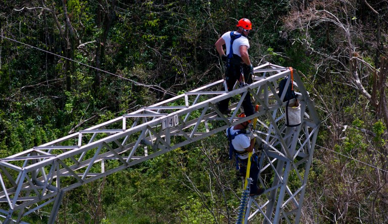 Whitefish Energy Holdings workers are now restoring power lines damaged by Hurricane Maria in Puerto Rico. Whitefish CEO Andy Techmanski said previous work restoring transmission lines damaged by wildfires in the western U.S. has prepared them for the Puerto Rico contract. (AP Photo/Ramon Espinosa)