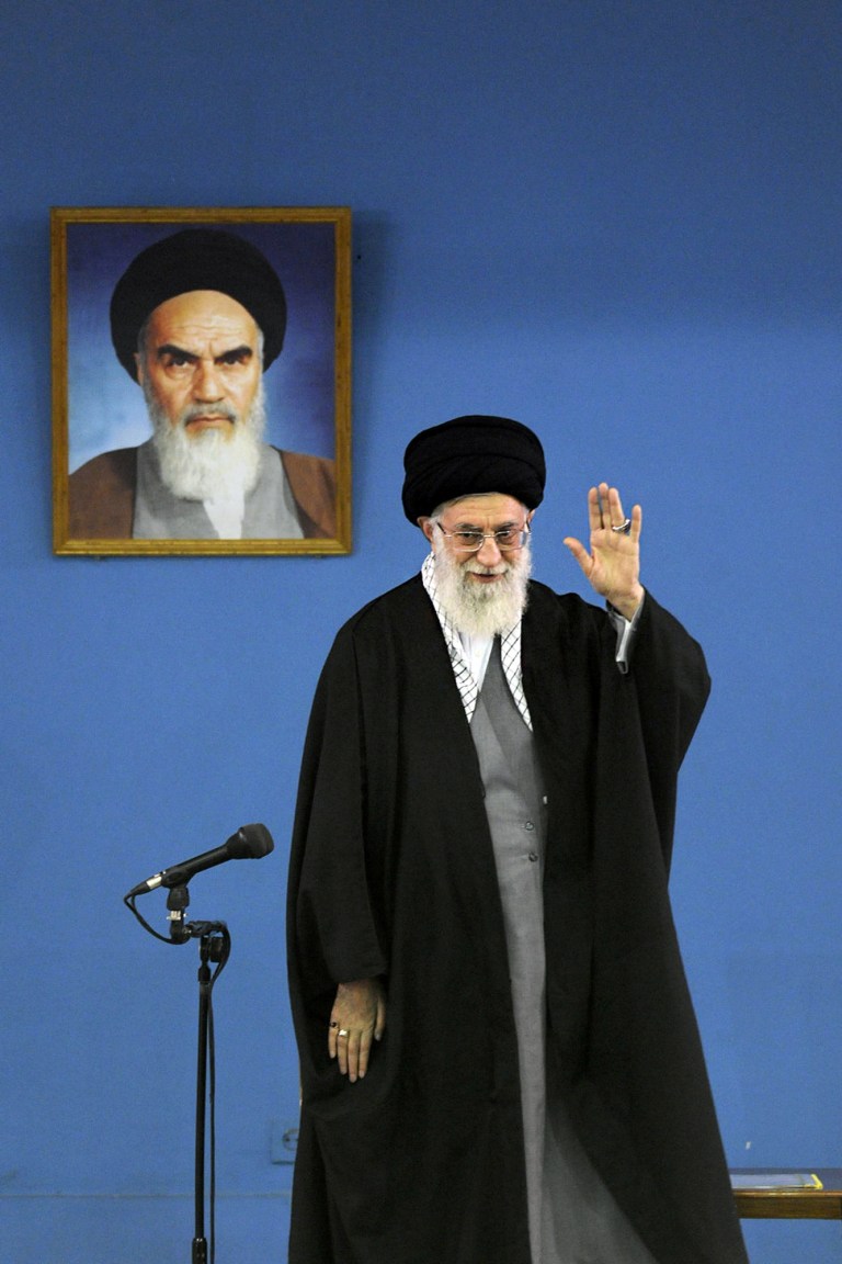 In this photo released by an official website of the Iranian Supreme Leader's Office, Iran's Supreme Leader Ayatollah Ali Khamenei waves at Iranian military members during their meeting in Tehran, Iran, Saturday, Feb. 8, 2014. Khamenei urged officials Saturday not to pin hopes for economic recovery on the sanctions relief from a landmark deal reached with world powers on Tehran's nuclear program. Khamenei also called on critics of the interim nuclear deal achieved on Nov. 24 in Geneva to be fair and give time to President Hassan Rouhani to pursue his policy of engagement with the outside world. (AP Photo/Iranian Supreme Leader's Office)