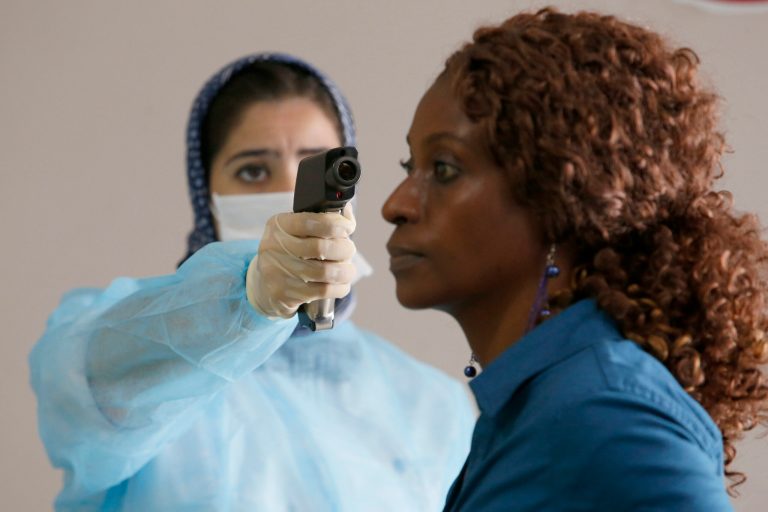 A Moroccan health worker uses a thermometer to screen a passenger at the arrivals hall of the Mohammed V airport in Casablanca, Thursday, Oct 9, 2014. Air Maroc, along with Air France and Brussels Airlines, are still flying to Ebola-hit West Africa, with the backing of the World Health Organization. The WHO has urged the airlines to keep flying, saying the risk to public health from air travel itself is low and that flights bring needed aid workers and supplies. Airlines have to balance that against safety concerns which have led British Airways and Emirates to suspend service. (AP Photo/Abdeljalil Bounhar)