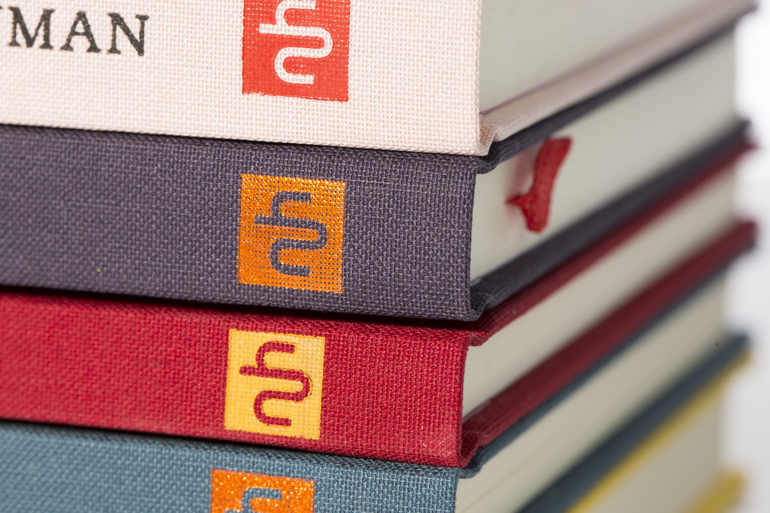 The publisher's logo on the spines of books from Notting Hill Editions.