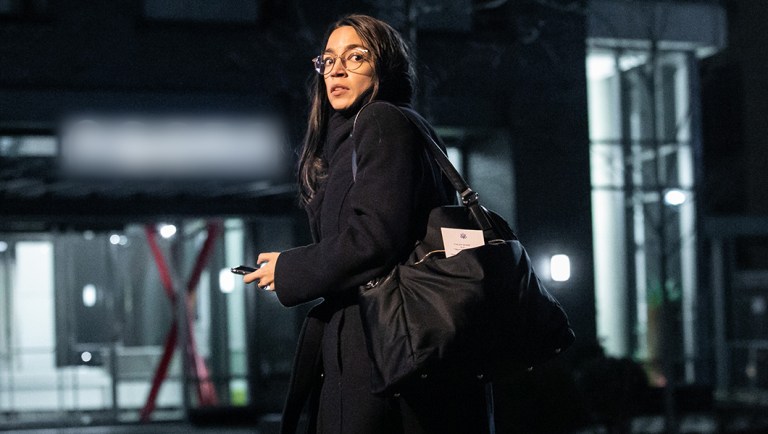 Rep. Alexandria Ocasio-Cortez outside her apartment complex last week. This photograph has been altered to obscure the name of the building.