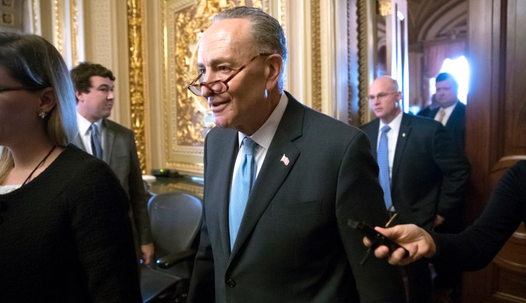 Senate Minority Leader Chuck Schumer, D-N.Y., heads to the chamber with fellow Democrats for a procedural vote aimed at reopening the government, at the Capitol in Washington, Monday, Jan. 22, 2018. (AP Photo/J. Scott Applewhite)