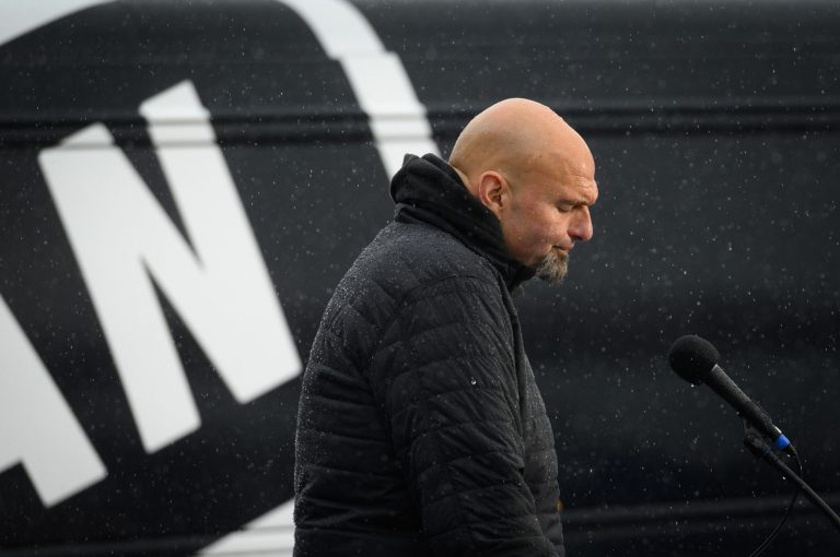 John Fetterman, lieutenant governor of Pennsylvania and Democratic senate candidate, speaks as heavy rains fall during a campaign rally in Pittsburgh, Pennsylvania, on Oct. 1.