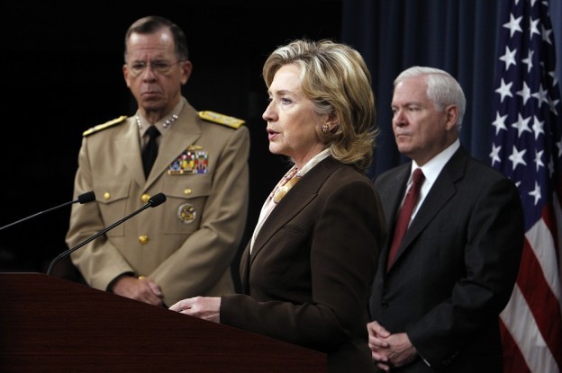 Former Secretary of State Hillary Rodham Clinton speaks to reporters with former Chairman of the Joint Chiefs of Staff Adm. Michael Mullen and former Defense Secretary Robert Gates in 2010. (AP Photo/Charles Dharapak)