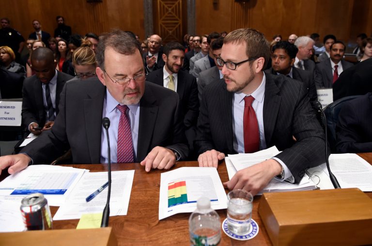 Office of Personnel Management Chief Information Officer Tony Scott, left, looks over papers with Assistant Secretary of Office of Cybersecurity and Communications National Protection and Programs Directorate at the Department of Homeland Security Andy Ozment, Ph.D, right, before the start of the Senate Homeland Security and Governmental Affairs Committee hearing. (AP Photo/Susan Walsh)