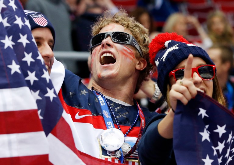 U.S. fans cheer as Russia and the USA take the ice before playing in a men's ice hockey game at the 2014 Winter Olympics, Saturday, Feb. 15, 2014, in Sochi, Russia. (AP Photo/Mark Humphrey)