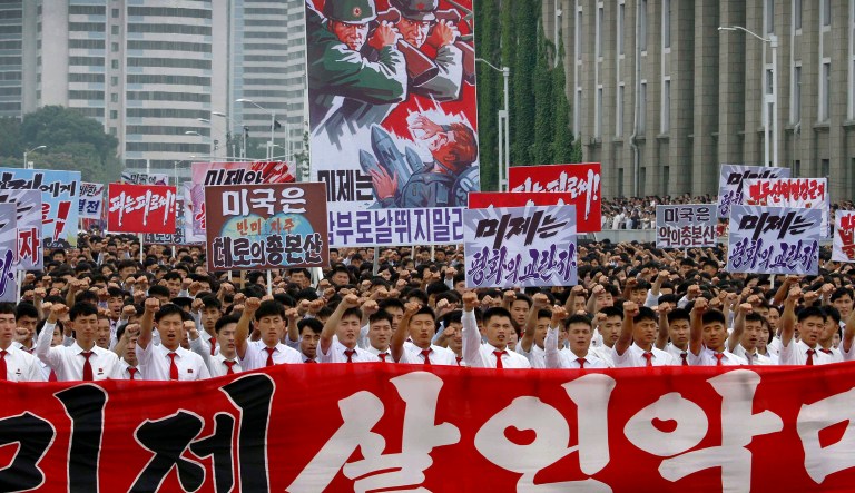 Tens of thousands of men and women pump their fists in the air and chant 
