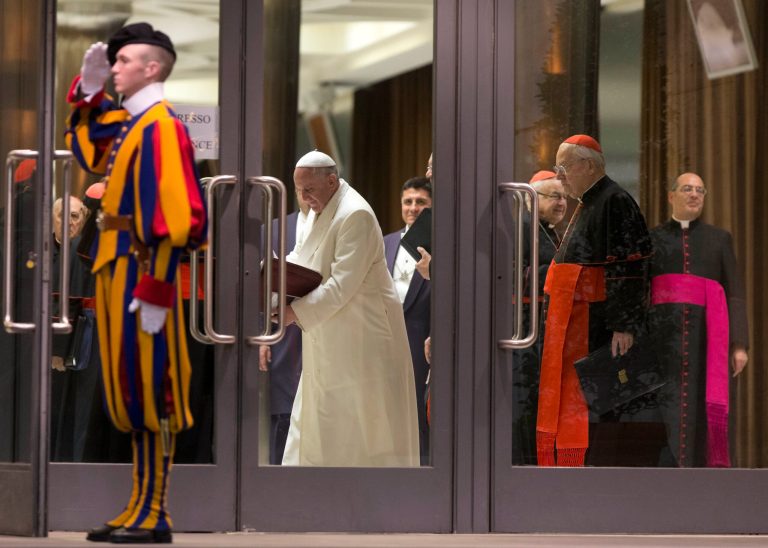 Pope Francis leaves at the end of the afternoon session of an extraordinary consistory in the Synod hall at the Vatican City, Thursday, Feb. 20, 2014. Cardinals from around the globe have begun discussing some of the most contentious issues in the church amid findings from Vatican-mandated surveys that most Catholics reject church teaching on contraception, divorce and homosexuality. Pope Francis opened the two-day meeting Thursday by urging his cardinals to find 